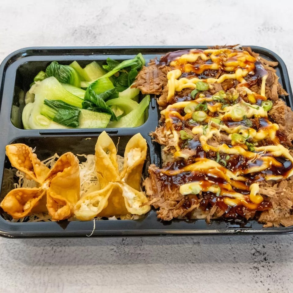 Takeout container with shredded beef, bok choy, and crab rangoons on a white background.
